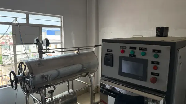 A horizontal steam autoclave and its control panel in the sterilisation room.