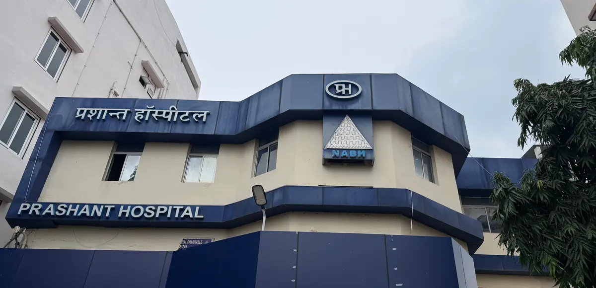 The hospital building on Juran Chapra Road, with the name above the entrance in English and Hindi.