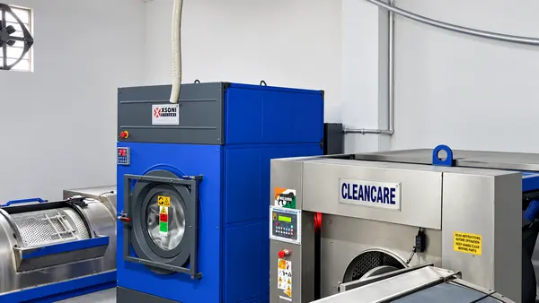 Industrial washer-extractors in the hospital laundry, where linen is processed on site.